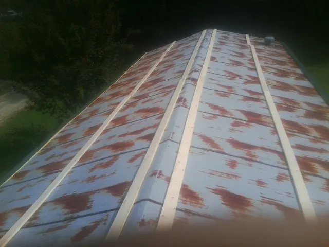 Rusted metal roof panels with new wood purlins before replacement — Storm Damage Roof Repair in Mount Pleasant by Roofing Brothers