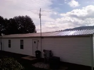 New metal roof on a single wide mobile home with a TV antenna in Mount Pleasant